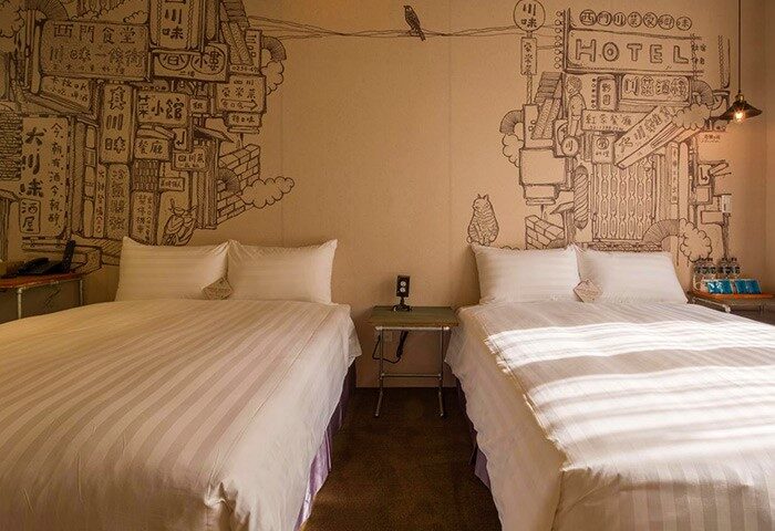 Cho Hotel room with twin beds, artistic wall drawings. Gay-friendly hotel with unique design for gay travelers. Taiwan accommodation.