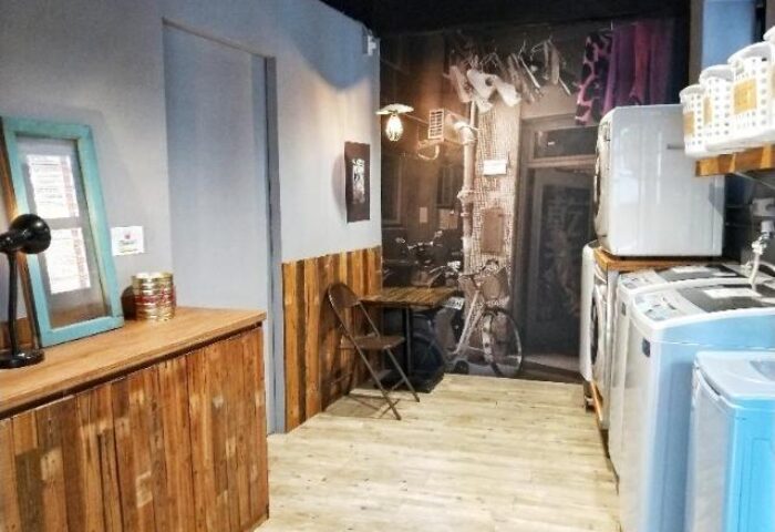 Cho Hotel's laundry room. Gay-friendly hotel features washing machines, dryer, and a vintage-themed wallpaper. Great for gay travelers.