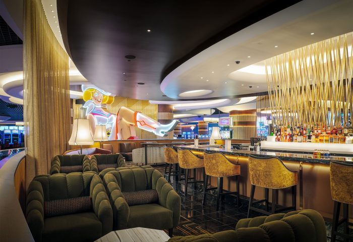 Circa Resort and Casino's adults-only bar. A gay-friendly hotel with a neon cowgirl sign, plush seating, and a fully stocked bar.