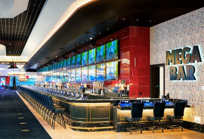 Mega Bar at Circa Resort and Casino, an adults-only, gay-friendly hotel. Long bar with many TVs, perfect for gay men travel.