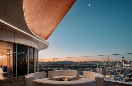 Circa Resort and Casino adults-only rooftop lounge at night. Gay-friendly hotel with fire pit, seating, and Las Vegas skyline views.