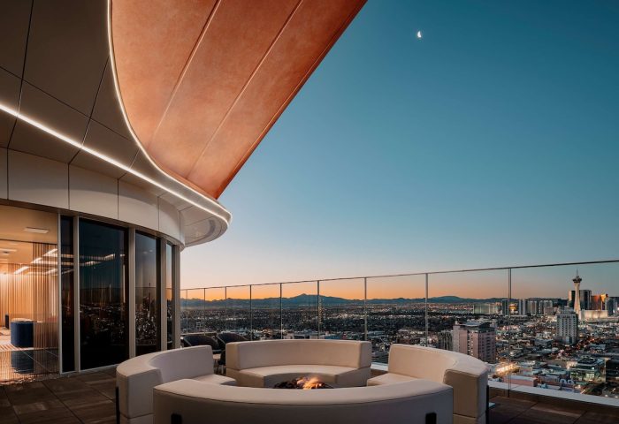 Circa Resort and Casino adults-only rooftop lounge at night. Gay-friendly hotel with fire pit, seating, and Las Vegas skyline views.