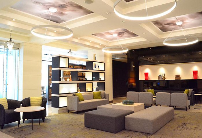 Citadines Central Shinjuku Tokyo lobby. Gay-friendly hotel with modern design, stylish seating, and unique lighting. A comfortable space for travelers.