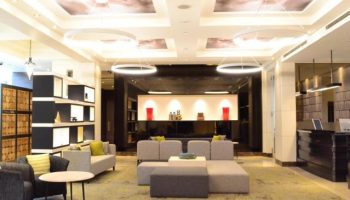 Citadines Central Shinjuku Tokyo lobby. Gay-friendly hotel with modern design, seating area, and unique lighting. Perfect for gay travel.