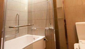 Bathroom at Citadines Central Shinjuku Tokyo, a gay-friendly hotel. Features a bathtub, shower, and modern toilet for a comfortable stay.