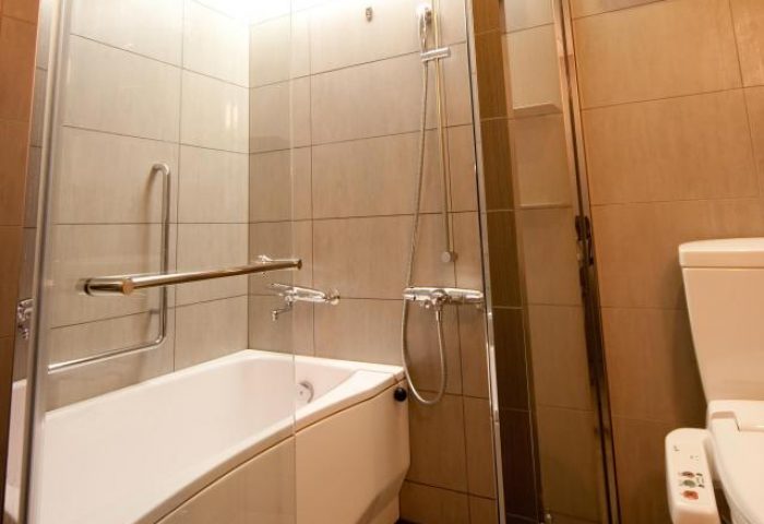 Bathroom at Citadines Central Shinjuku Tokyo, a gay-friendly hotel. Features a bathtub, shower, and modern toilet for a comfortable stay.