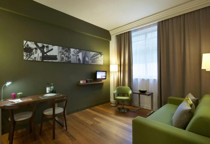 Citadines Holborn-Convent Garden London room. Gay-friendly hotel with desk, sofa, chair, and TV. Modern apartment in London for gay travelers.