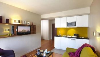 Citadines Les Halles Paris apartment interior. Gay-friendly, pet-friendly hotel with kitchen, TV, and modern design. Ideal for gay travelers.