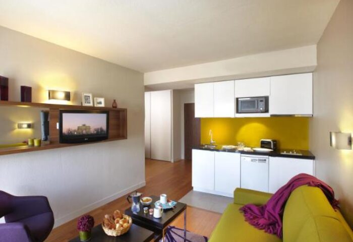 Citadines Les Halles Paris apartment interior. Gay-friendly, pet-friendly hotel with kitchen, TV, and modern design. Ideal for gay travelers.