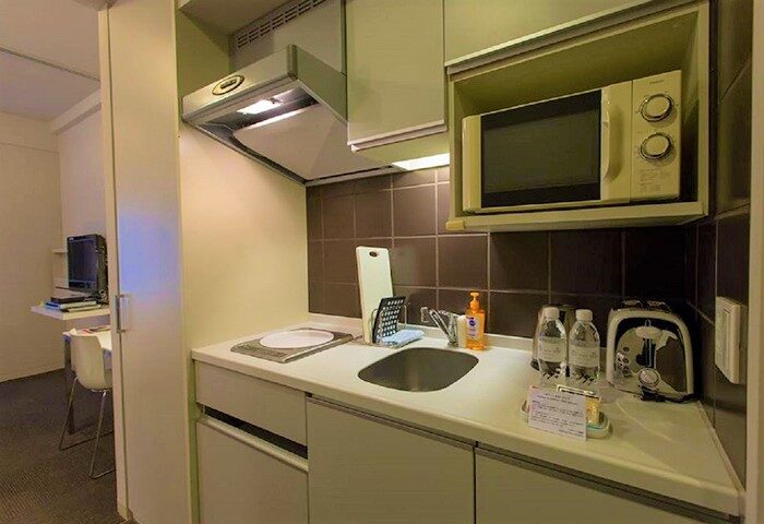 Citadines Shinjuku Hotel's kitchenette. This gay-friendly hotel offers amenities like a microwave, toaster, and sink, perfect for gay travelers in Tokyo.