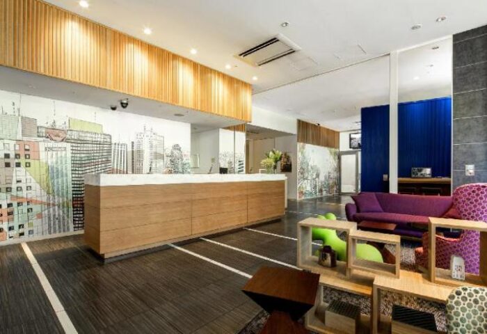 Citadines Shinjuku Hotel lobby. Gay-friendly hotel with modern design, front desk, and colorful seating. Ideal for gay travel in Shinjuku, Tokyo.