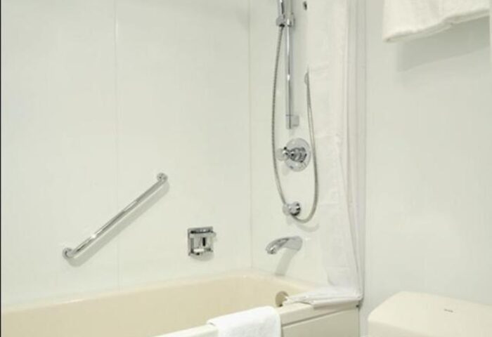 Bathroom at Citadines Shinjuku Hotel, a gay-friendly hotel in Tokyo. Features a shower, bathtub, grab bar, and accessible toilet for gay travelers.