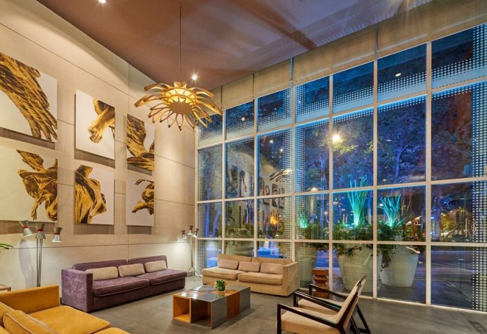 City Express Plus by Marriott Ciudad de México Reforma El Ángel lobby. Gay-friendly hotel interior with modern art and large windows.