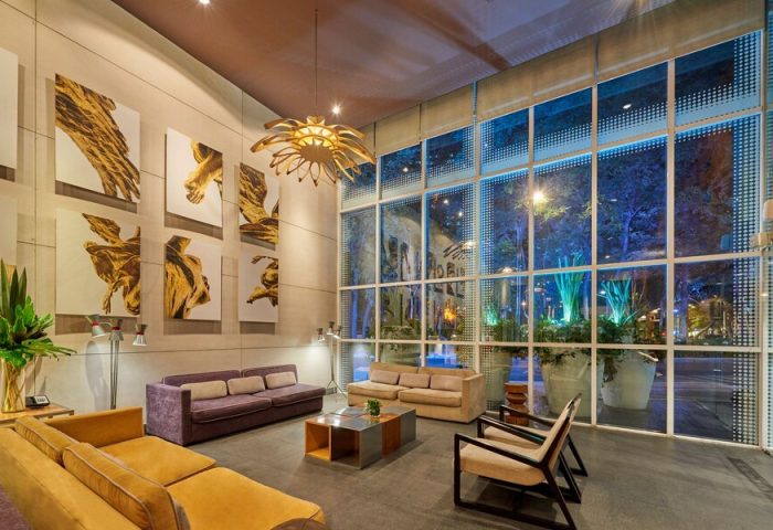 City Express Plus by Marriott Ciudad de Mexico Reforma El Angel lobby. Gay-friendly hotel with modern design, art, and comfortable seating.