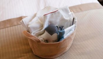 Amenities basket at City Hotel Lonestar, a gay-friendly hotel. Includes towels, hairdryer, and toiletries. Perfect for gay travel.