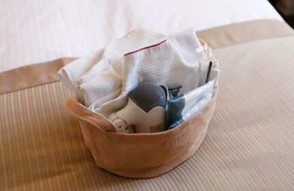 Amenities basket at City Hotel Lonestar, a gay-friendly hotel. Includes towels, hairdryer, and toiletries. Perfect for gay travel.