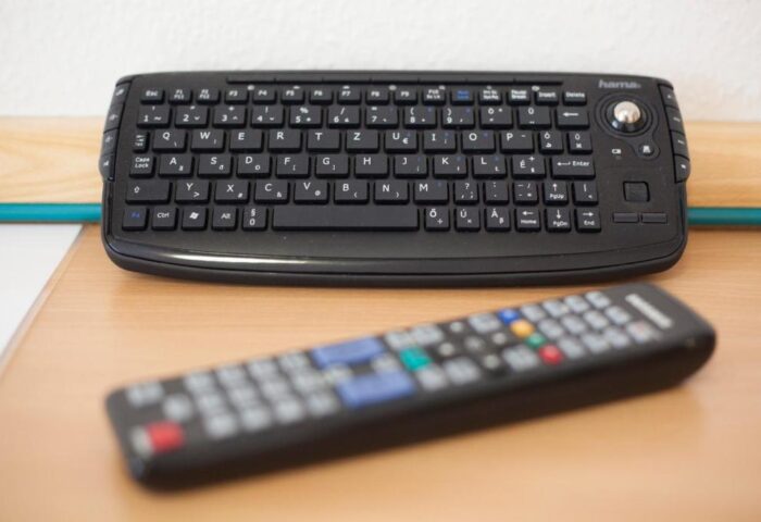 City Hotel Matyas: A keyboard and remote control on a desk. Gay-friendly hotel room detail for digital comfort. A modern touch for the discerning traveler.