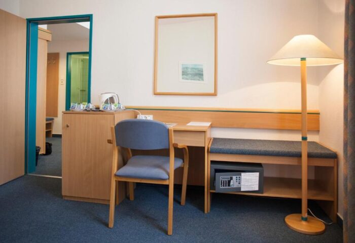City Hotel Matyas guest room. Desk, chair, safe, and lamp. Gay-friendly hotel for gay men travelers. Comfortable and secure.