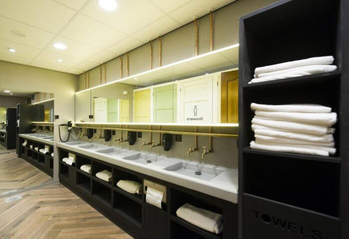 CityHub Amsterdam's stylish bathroom. This gay-friendly hotel features modern sinks, brass fixtures, and a towel shelf. Great for gay travelers.