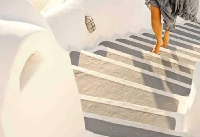 Cliff Side Suites gay-friendly hotel: Barefoot person walking down white stairs. Travel advice for gay men.