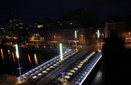 Night view from Clifton Court Hotel, a gay-friendly hotel. Dublin's illuminated bridge over the River Liffey, near the hotel. Cityscape.