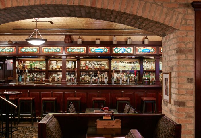 Club Quarters Hotel, Central Loop bar. Gay-friendly hotel with a fully stocked bar, stools, and booths. The bar has stained glass decor.