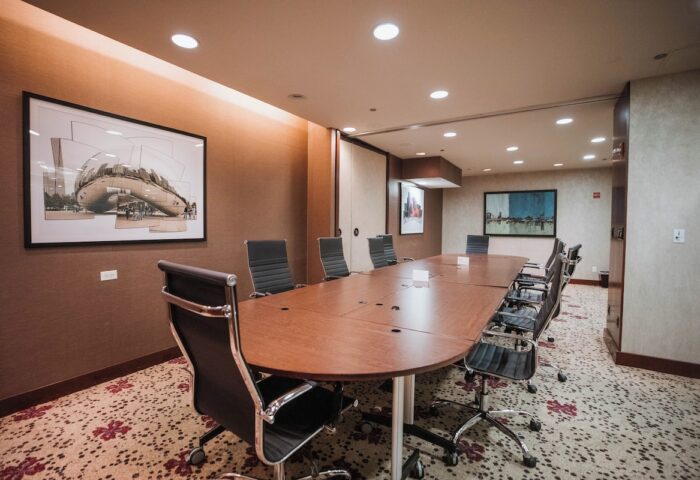 Club Quarters Hotel, Central Loop meeting room. Gay-friendly hotel featuring a conference table, chairs, and Chicago artwork.