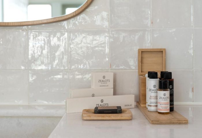 Coco-mat Athens BC gay-friendly hotel: Bathroom amenities. Zealots of Nature toiletries on a wooden tray. Minimalist design, perfect for gay travel.