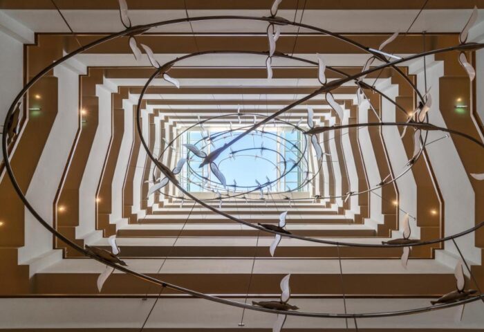Coco-mat Athens BC hotel atrium view. Gay-friendly hotel with unique design elements. Architectural detail, light fixture, and open ceiling.