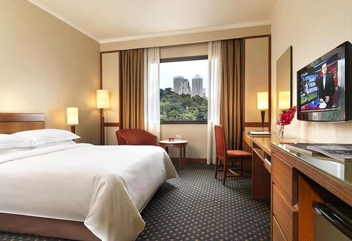 Concorde Hotel Kuala Lumpur room. Gay-friendly hotel with bed, TV, desk, and city view. Modern decor for a comfortable stay in Kuala Lumpur.