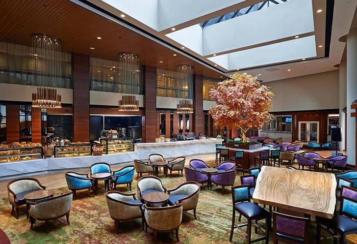Lobby lounge at the gay-friendly Concorde Hotel Kuala Lumpur. Stylish seating, bakery, and warm lighting create an inviting atmosphere.
