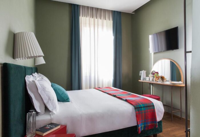 Condominio Monti Boutique Hotel's gay-friendly room. Bedroom with double bed, breakfast, and TV. Gay travel in Rome, Italy.