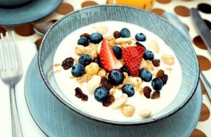 Breakfast at Condominio Monti Boutique Hotel, a gay-friendly hotel. Yogurt bowl with blueberries, strawberries, nuts, and juice.