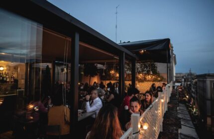 Condominio Monti Boutique Hotel's rooftop bar at dusk. A gay-friendly hotel in Rome, Italy, offering a stylish and welcoming experience.