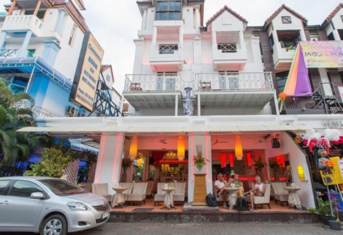 Connect Guesthouse, a gay-friendly hotel. Exterior view, showing the facade, outdoor seating, and street view. A welcoming space for gay travelers.