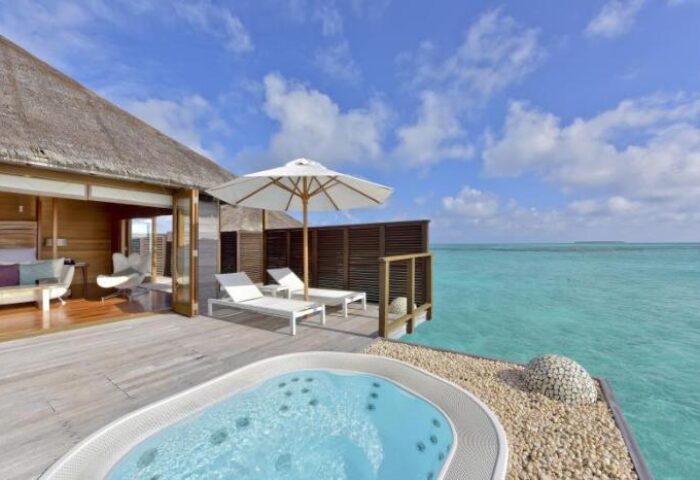 Conrad Maldives Rangali Island Resort: Gay-friendly hotel overwater bungalow with jacuzzi, lounge chairs, and ocean view. Perfect for gay travel.