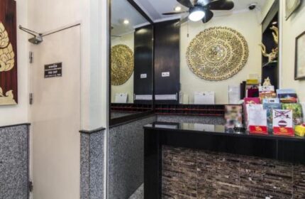 Copa Hotel's reception area. A gay-friendly hotel featuring a decorative wall art, a ceiling fan, and a modern front desk with travel brochures.