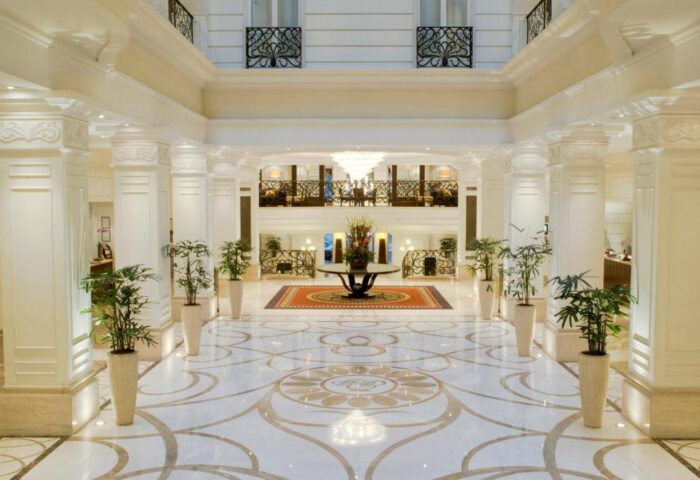 Corinthia Hotel Budapest lobby. Interior view of this gay-friendly, pet-friendly hotel. Elegant design with marble floors and potted plants.