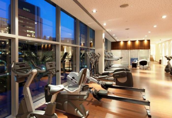 Corinthia Hotel Lisbon gym with cardio machines. Gay-friendly, pet-friendly hotel fitness center. Exercise bikes, treadmills, and rowing machines.