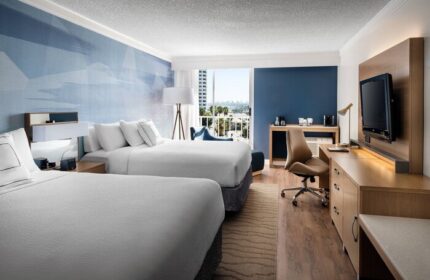 Courtyard Long Beach Downtown hotel room. Two beds, desk, TV, and balcony. Gay-friendly hotel in Long Beach, CA for gay men travel.