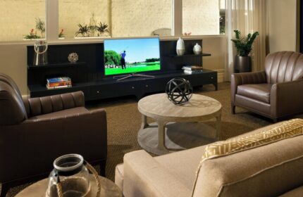 Courtyard Long Beach Downtown hotel room. Gay-friendly hotel with TV, leather chairs, and coffee table. Ideal for gay men travel.