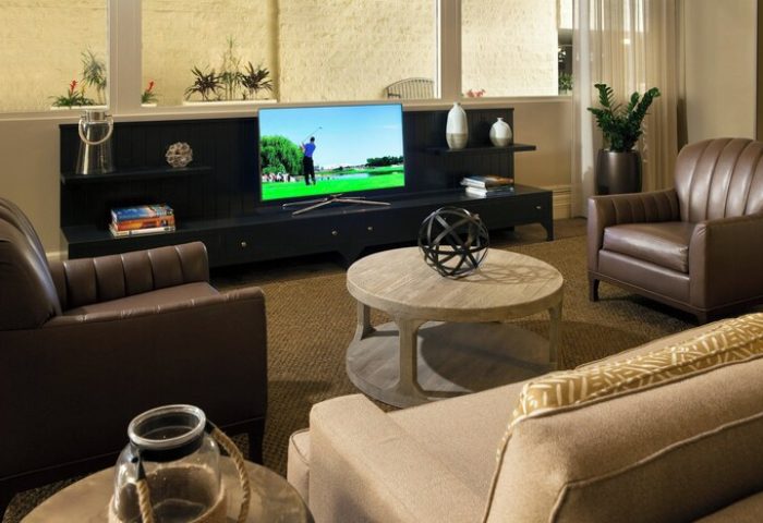 Courtyard Long Beach Downtown hotel room. Gay-friendly hotel with TV, leather chairs, and coffee table. Ideal for gay men travel.