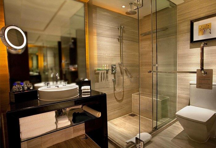 Bathroom at Courtyard by Marriott Shanghai Xujiahui, a gay-friendly hotel. Features a modern sink, shower, & toilet for comfortable stay.
