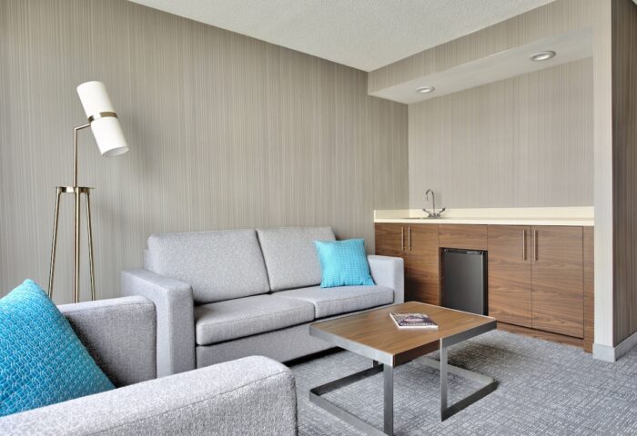 Courtyard by Marriott Toronto Downtown room. Gay-friendly hotel with seating area, wet bar, & modern decor. Ideal for gay travel in Toronto.