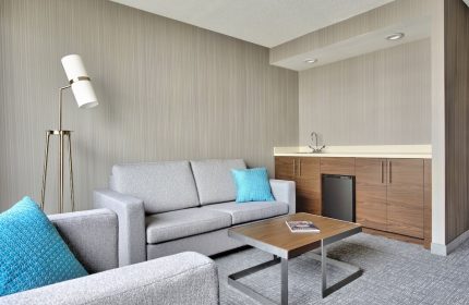 Courtyard by Marriott Toronto Downtown room. Gay-friendly hotel with seating area, wet bar, & modern decor. Ideal for gay travel in Toronto.