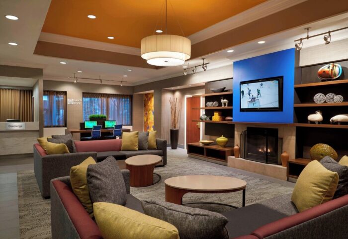 Courtyard by Marriott Toronto Downtown lobby. Gay-friendly hotel with lounge, TV, fireplace, and workspace. Modern interior design.