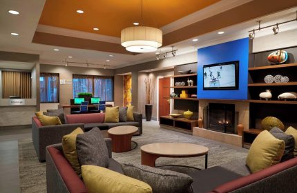 Courtyard by Marriott Toronto Downtown lobby. Gay-friendly hotel with lounge, TV, fireplace, and workspace. Modern interior design.
