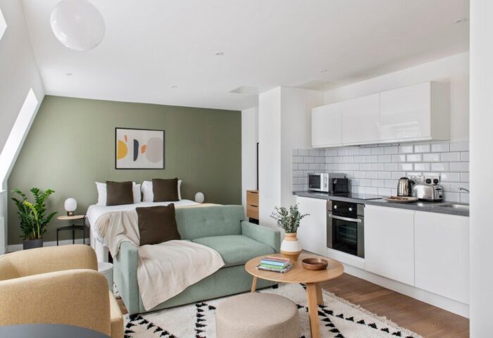 Cove Minshull Street gay-friendly hotel room. Modern studio apartment with bed, sofa, kitchen. Stylish interior for gay men travel.