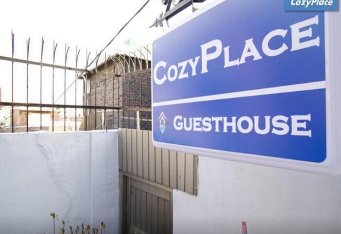 CozyPlace Guesthouse sign in Itaewon. A gay-friendly hotel offering cozy rooms and a welcoming atmosphere for gay travelers in Seoul, South Korea.