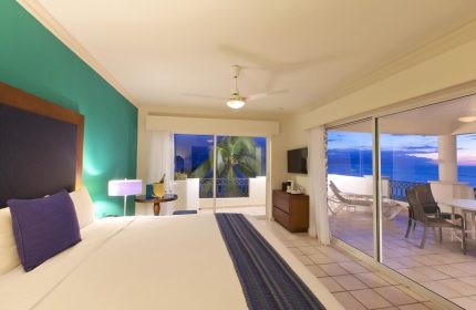Crown Paradise Golden Adults Only gay-friendly hotel room. Balcony view, ocean, bed, and modern decor. All-inclusive resort for gay men.